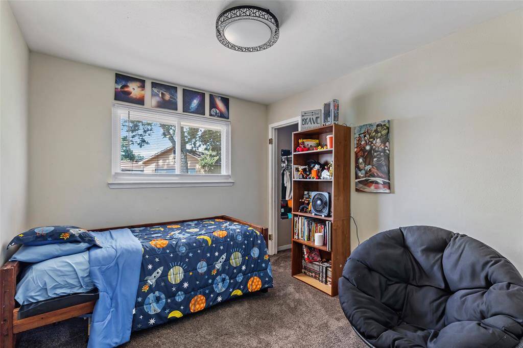 Bedroom with new carpet, lighting, fresh neutral paint and walk in closet.