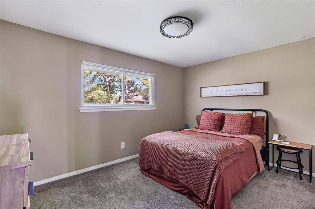 Large primary suite with its own half bath, new carpet, new lighting, and fresh neutral paint.