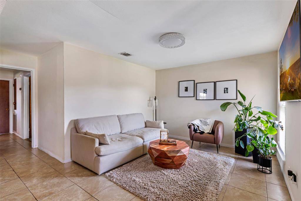 The living space is open to the kitchen and dining.