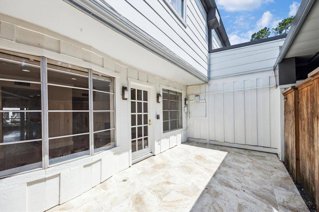Private back patio with access to the parking area.