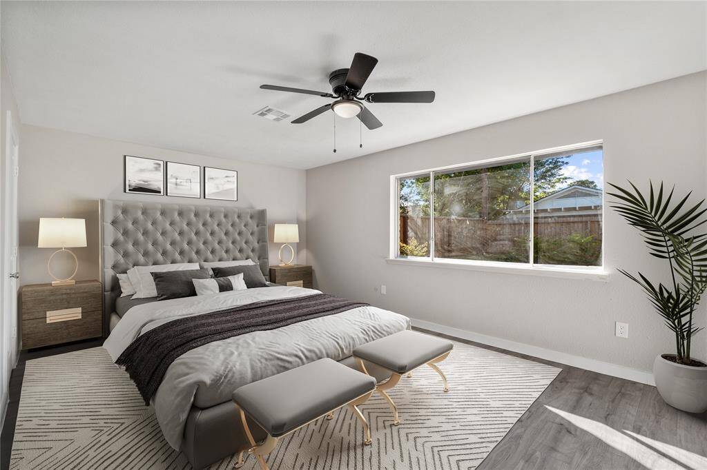With a large window offering a relaxing view of the pool, this primary bedroom provides a serene space to unwind and enjoy the tranquil surroundings. *Virtual staging*