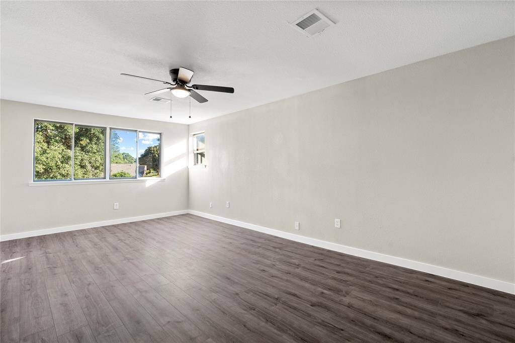 This 20x11 ft secondary bedroom offers a spacious layout, nearly as large as the primary bedroom, and features two walk-in closets for added storage.