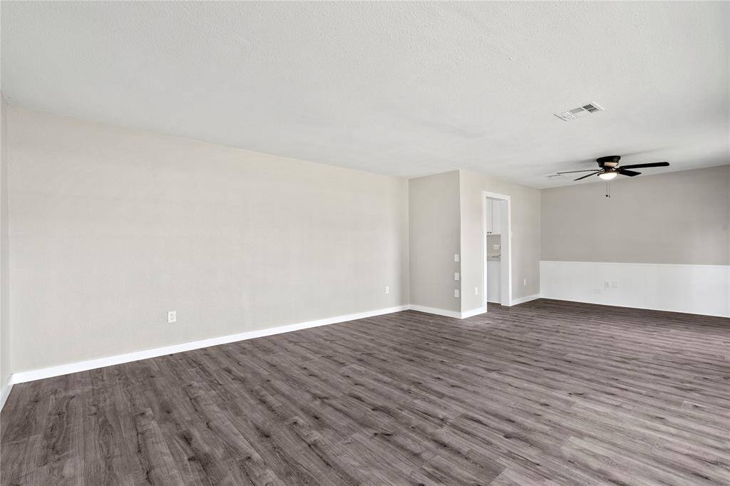 Both the living area and formal dining room flow seamlessly into the kitchen, creating a connected layout that works well for everyday routines and hosting alike.