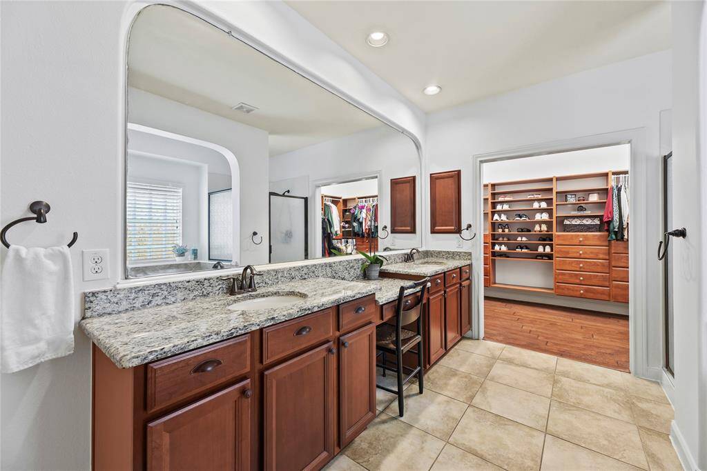 Exquisitely finished, the primary bedroom en suite has dual sinks and tons of storage cabinetry for self-care items. Each partner may easily get ready in the morning with ease and comfort.
