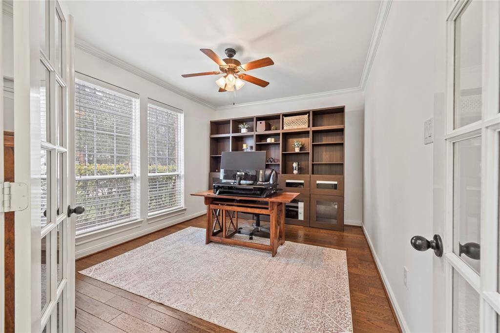 Double-French doors delightfully sequester the den in privacy. Telecommuters and work-at-home entrepreneurs may also utilize this space as a stylish office.