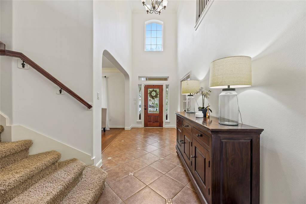 A second staircase leads to the upper level, where you'll find a media room, game room, several bedrooms, and additional bathrooms.
