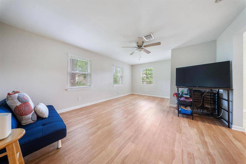 Extended living room offers ample space for gatherings and relaxation.