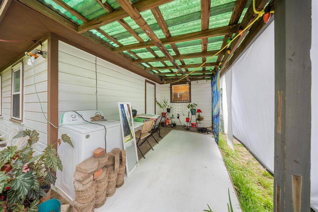 Inviting covered porch, the perfect spot to relax and take in the beauty of the backyard.