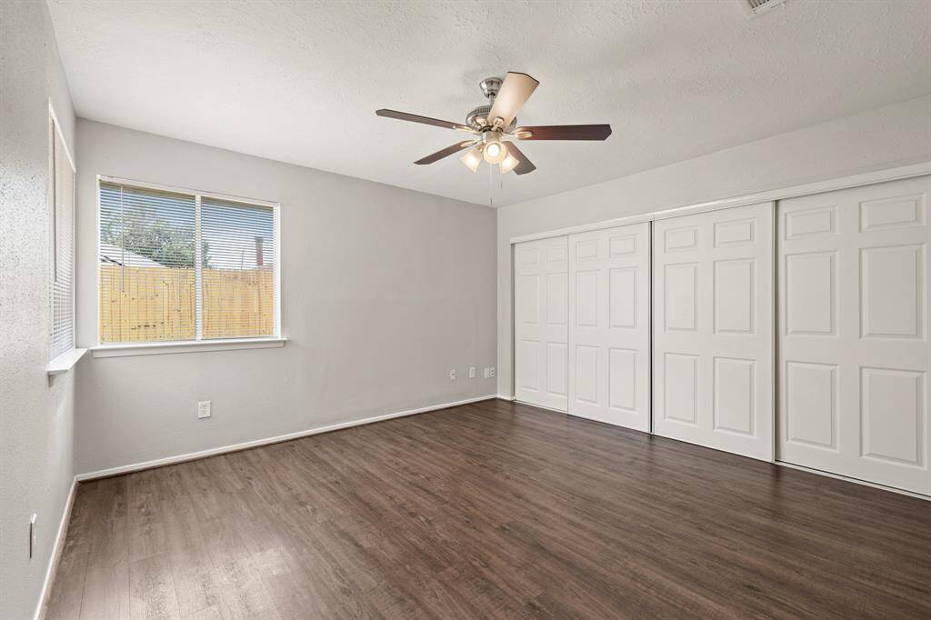 A wall of sliding doors opens up to your primary closet, offering plenty of storage and easy access to everything you need, all while keeping the space neat and organized.