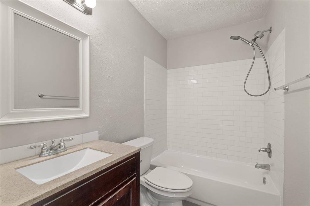 The primary bath is a serene retreat featuring a spacious vanity, elegant tub and shower combo, creating an ideal space for comfort and privacy.
