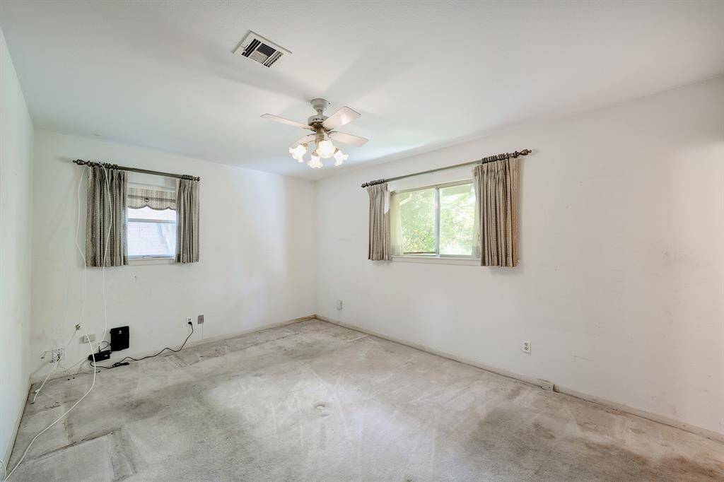 Primary bedroom is located on the back of the home with walk-in closet.