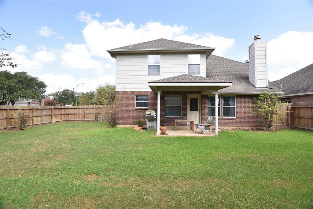 Spacious backyard with covered patio area
