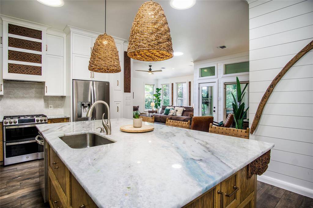 Kitchen flows beautifully into a breakfast nook/ cafe room & the living room. The beautiful yet functional design of the entire home will amaze you.