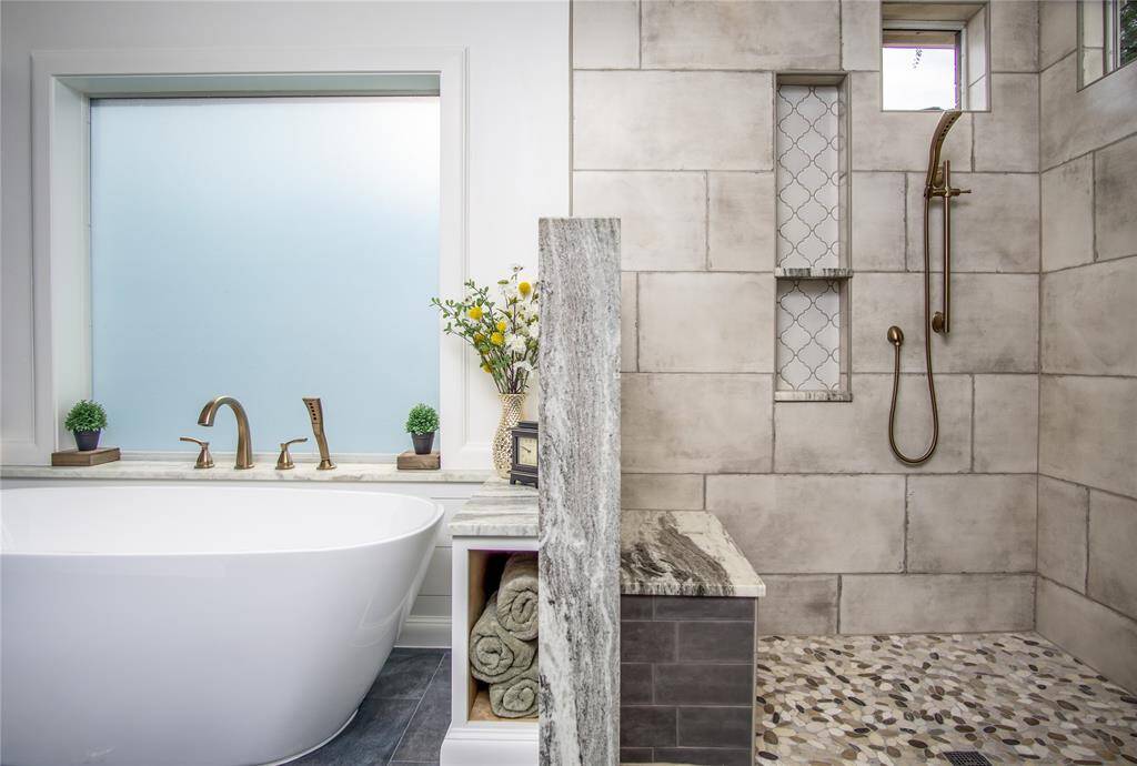 Deluxe primary bathroom is a true retreat! Extra spacious, walk-in, curb-less shower with dual shower heads & NO GLASS, gorgeous leathered granite finishes, shower bench & 2 shower wall niches.