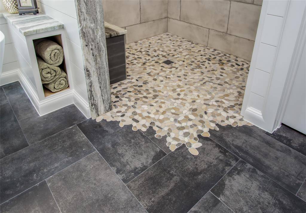 The tilework was installed with this custom cut-out pattern. Stunning & so functional with no curb & no glass needed!