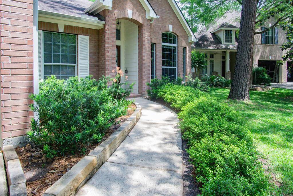 The front and rear landscaping have been designed and allowed to mature beautifully! Lovely curved walk way to the entry flanked by lush plants.