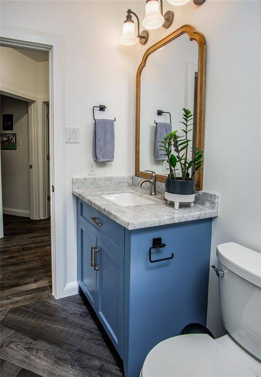 Custom built cabinetry with natural stone counter & undermount sink. Designer vanity lighting & a solar tube to allow the natural light as well!