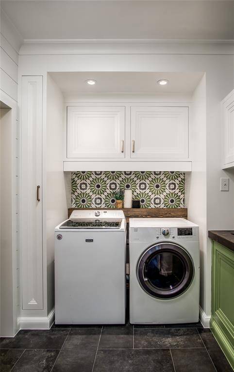 Splendid laundry room / mud room has many hidden design details: pull-out drying shelf, removable wooden shelf to access plumbing, access door from secondary bedrooms allows laundry to be deposited into laundry bins inside the cabinetry, Utility sink, stairs to access the bonus room, & garage access is to the left from the laundry room.