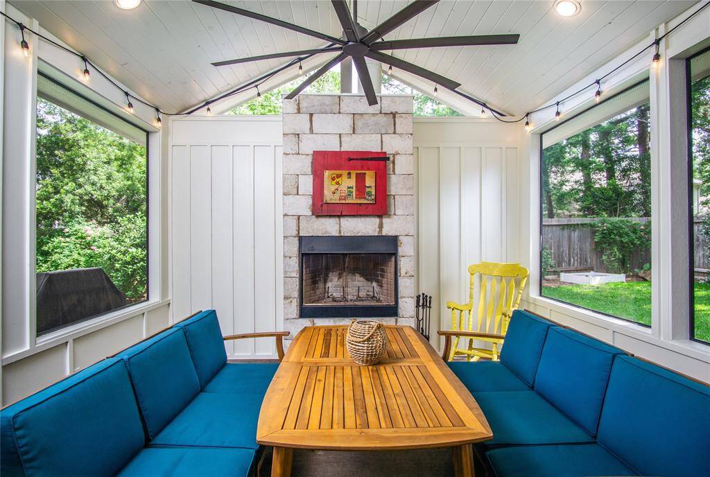 Perfect space to enjoy the lush backyard without being swarmed by bugs. Enjoy this screened-in patio year round! Fan above to keep you cool when it is warm & elevated fireplace to keep you warm & provide ambiance when it is cold. The board & batten paneled back wall & tile fireplace also double to provide SO MUCH PRIVACY for the home!