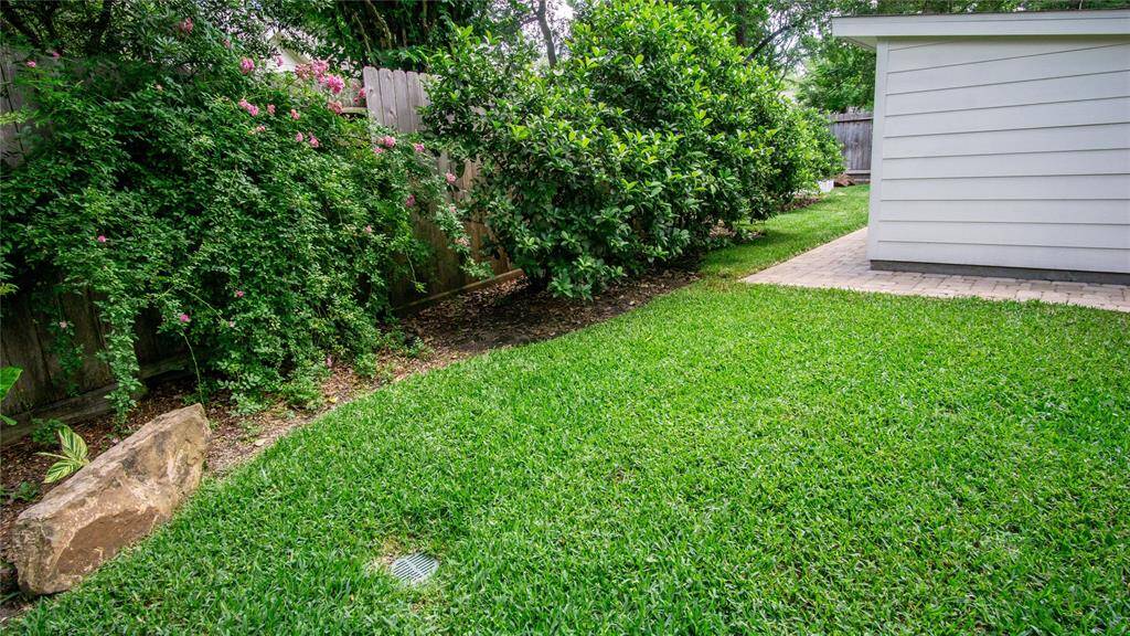 Landscaping boulders in the front & back were added. Large bushes for year-round green, & hardy roses planted, too. Notice the grading & drainage was also taken care of.  Huge shed placed discreetly in the back yard stores a ton of stuff, so you can actually use your garage!