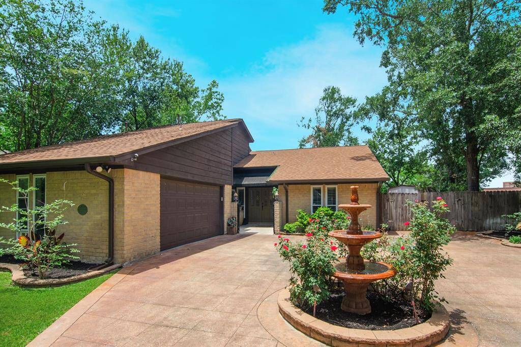 Front view of the home and the fountain in the driveway.