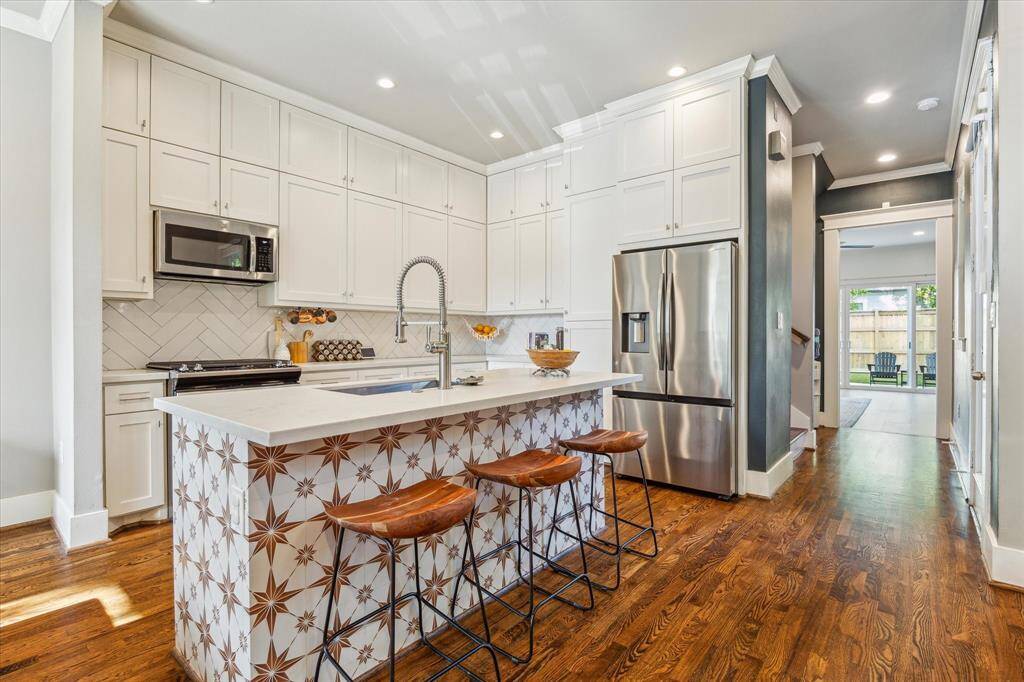 Floor-to-ceiling cabinets provide for an abundance of storage solutions as well as giving the space a more custom feel.