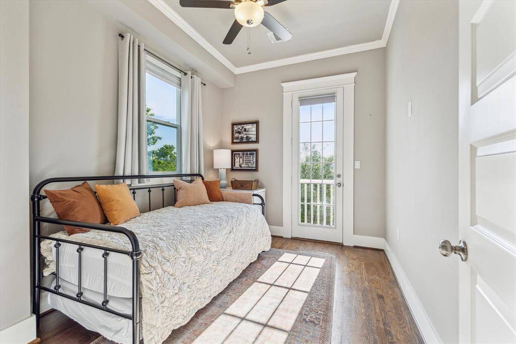 This cozy secondary bedroom is also located on the 2nd floor and features hardwood floors and ample natural light from a large window and glass door leading to a balcony. Currently being used as a guest room but could make a convenient office or work out space.