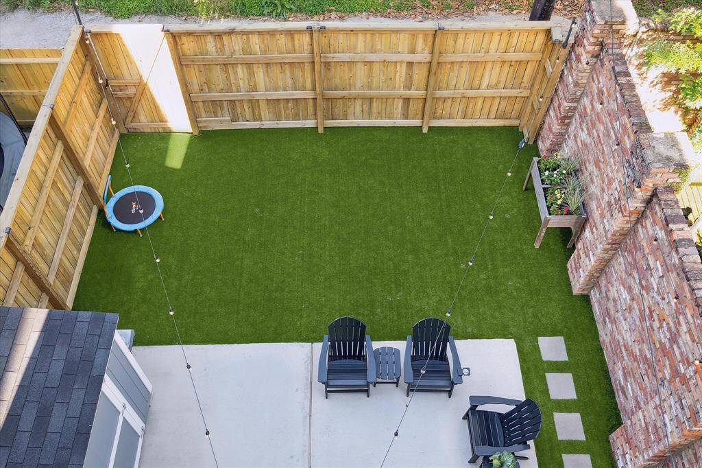 The backyard was fully re-landscaped with a new fence, turf and pavers.