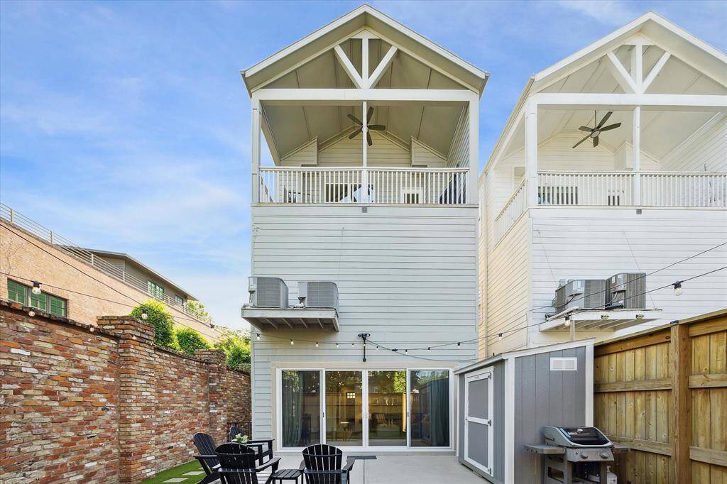 View of the backyard and the third floor balcony.