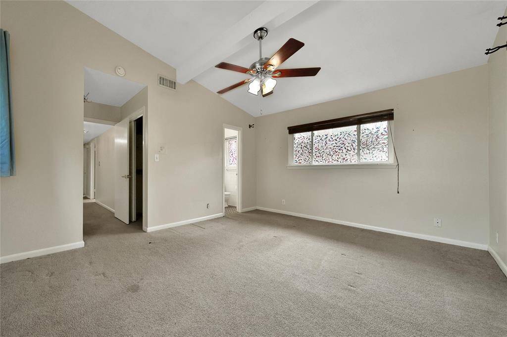 Primary bedroom features ensuite bathroom and high ceilings.