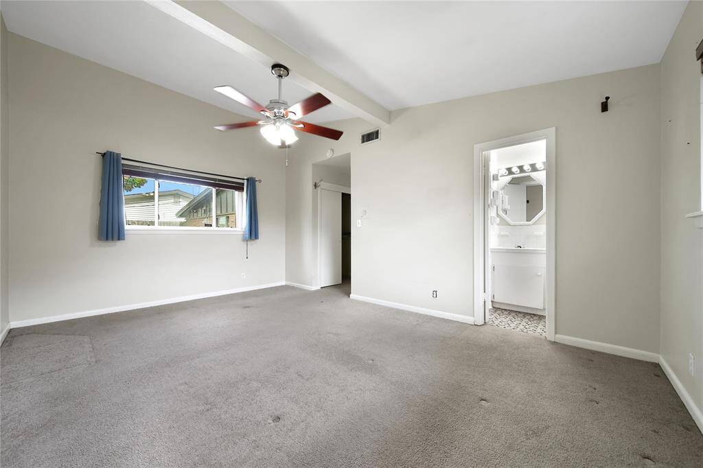 Primary bedroom features ensuite bathroom and high ceilings.