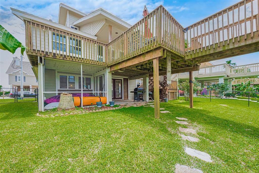 Just outside the flex space is a covered patio area and a screened in storage area as well