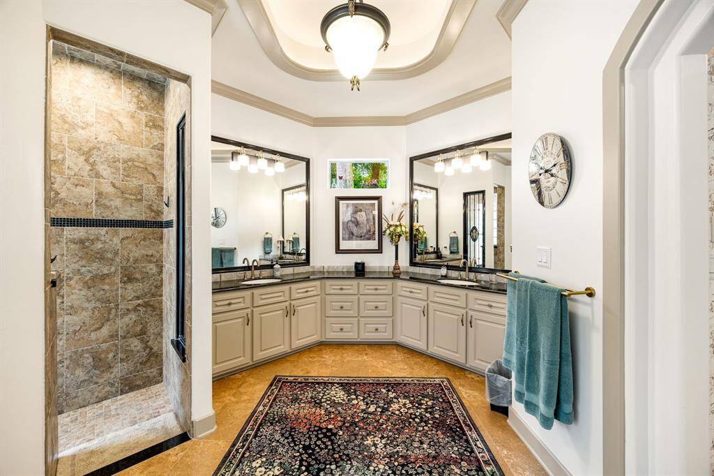 Primary en-suite bathroom with walk in shower, soaking tub and dual vanities