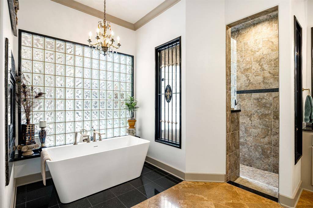 Primary bathroom with a luxurious soaking tub framed with block windows