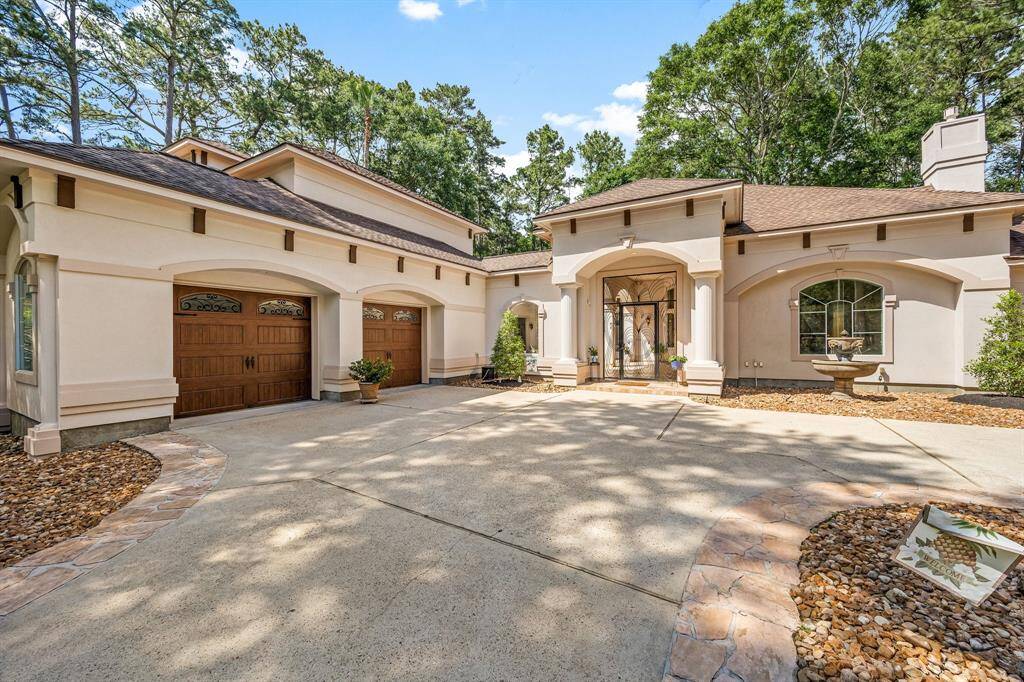 Walk through the front gate to the oasis courtyard. Double garage doors that provide access to the 3-car garage.