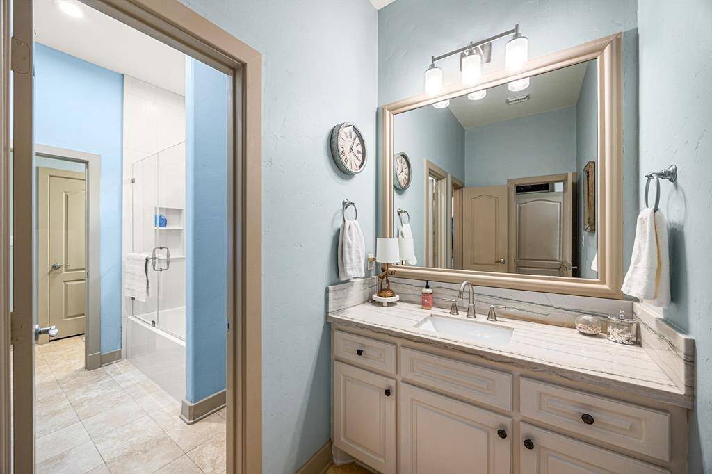 The secondary bedrooms are connected by a Jack and Jill bathroom, offering privacy and convenience with separate vanities and shared access.