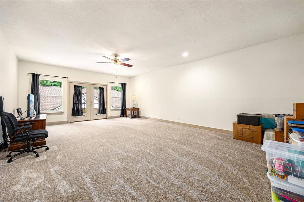 Upstairs living area of the cabana house with French doors and balcony. This is a versatile room that can be used for those overnight guests stays, game room, craft room, home gym or a quiet retreat -tailored to fit your lifestyle.