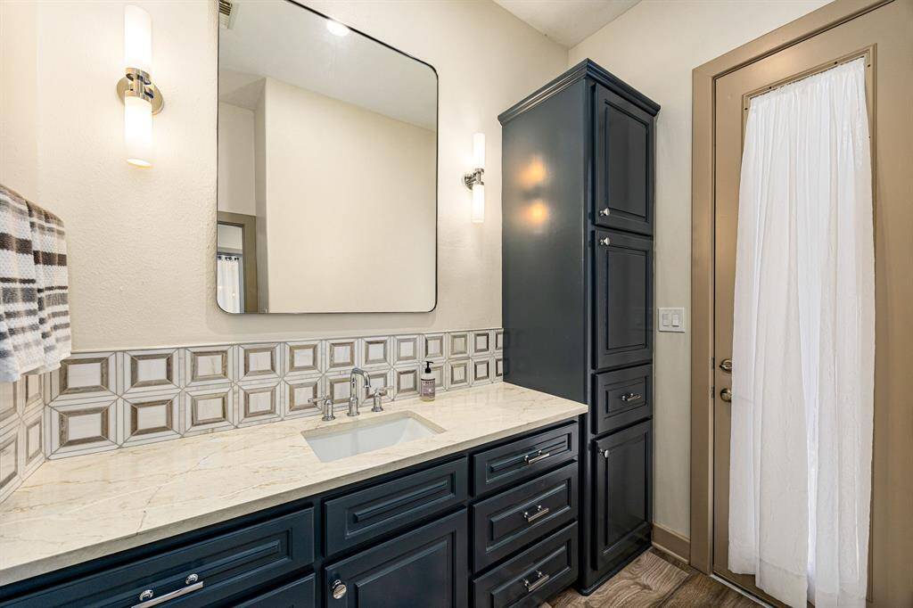 Cabana House full bathroom with built in cabinets and walk in shower