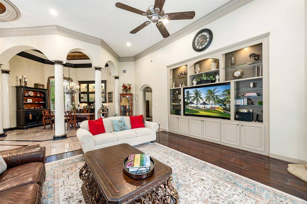 Elegant architectural pillars subtly define the space between the formal dining room and family room