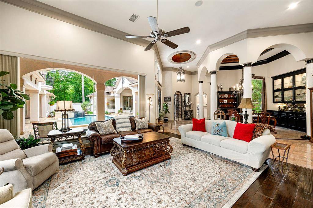 Family room open to the formal dining room with tons of natural light and view of the pool area