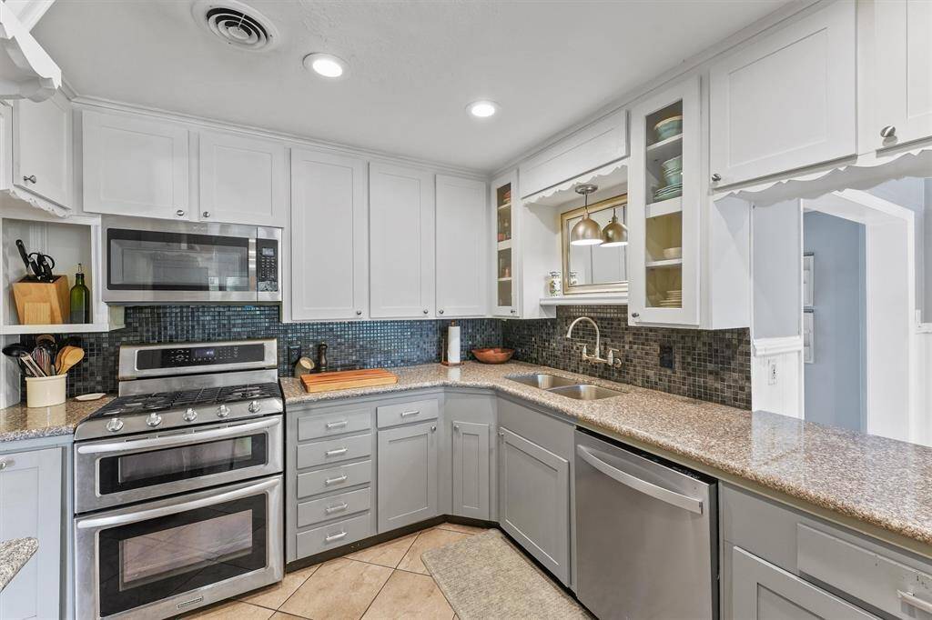 Kitchen offers recessed lighting, double oven, microwave, granite countertops and a breakfast bar.  Refrigerator stays!