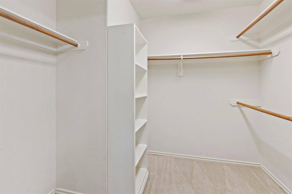 primary closet is large and includes shelves