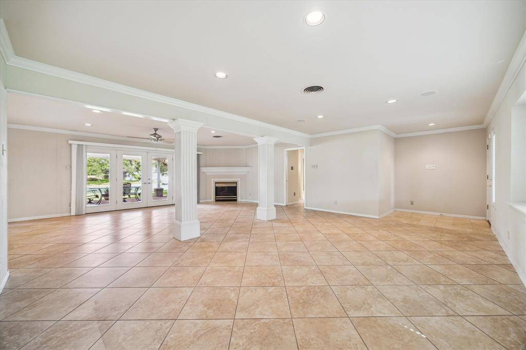 Upon entering the home you are me with a formal dining room, formal living room and a den. They are framed with French doors that open onto a beautiful backyard with a lake view and allow for natural light.