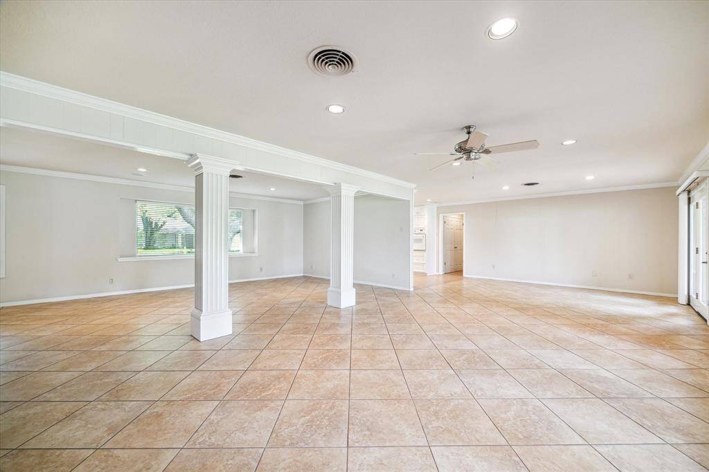 The size of the room is shown in the photo, and the window faces the front yard. The kitchen is on the left, and the hallway, with the half bathroom is to the right, tucked away in the hallway area.