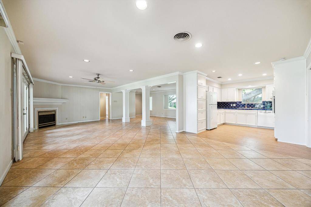 This is a picture of the kitchen and living area, which has a newly replaced electric cooktop and refrigerator.