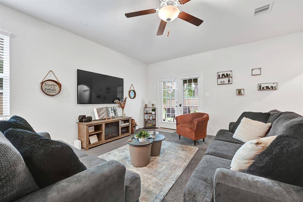 The large living space feels extra cozy with the soft, thick, well cared for carpeting.