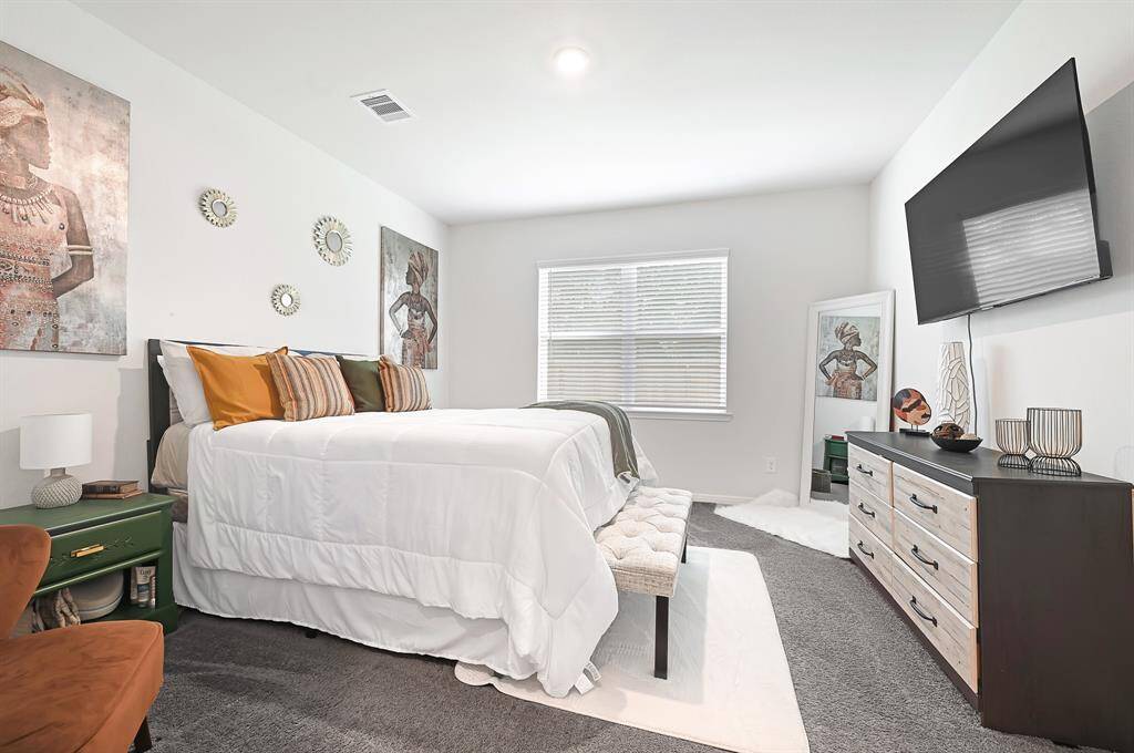The primary bedroom has an oversized window providing a good amount of natural light.