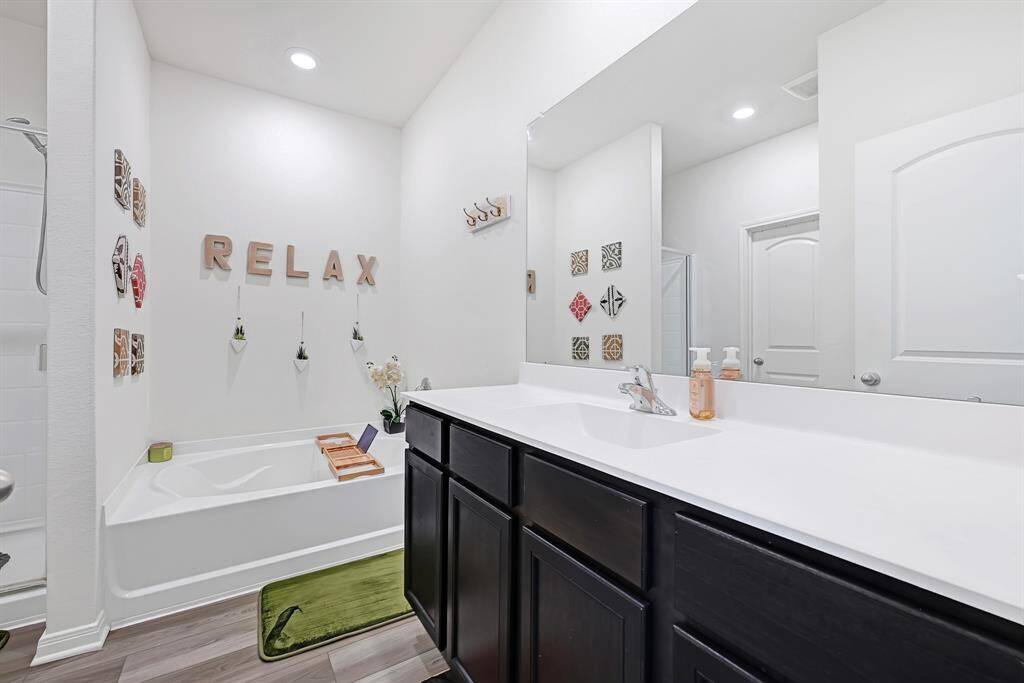 The primary bath has a large counter and lots of storage.
