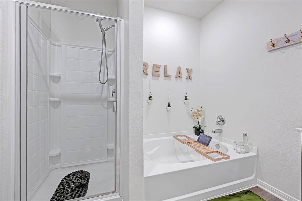 The large primary bath features a separate tub and shower.