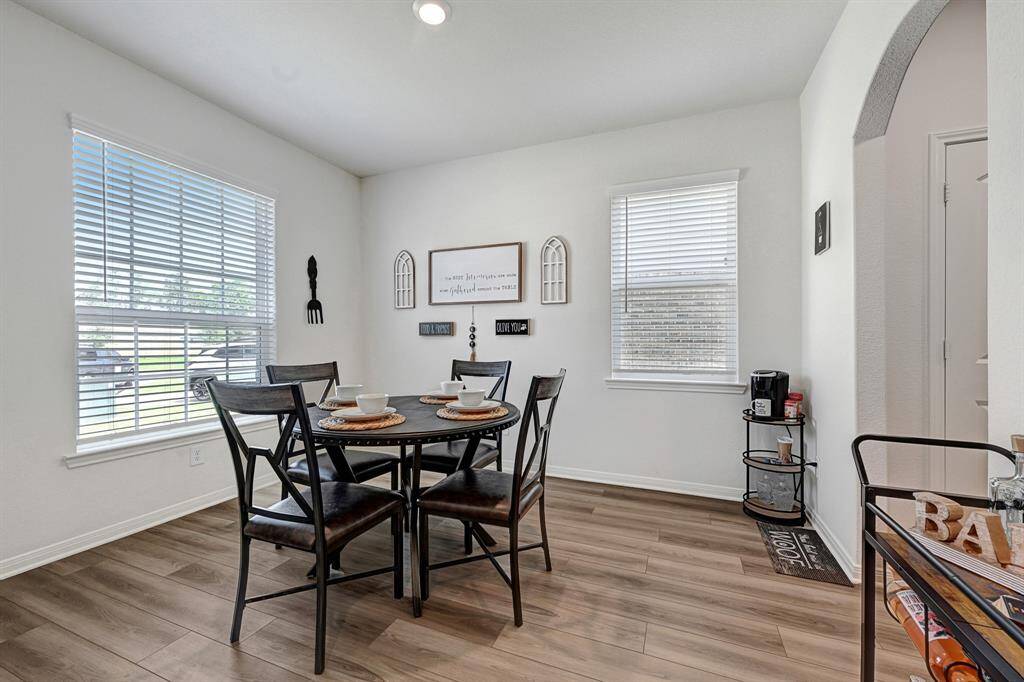 An oversized window provides natural light in the dining area.
